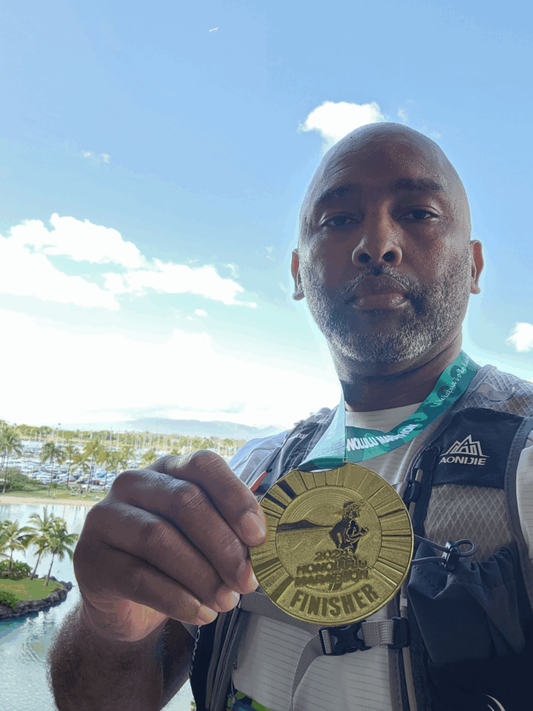 Displaying finisher medal after Honolulu Marathon 2024